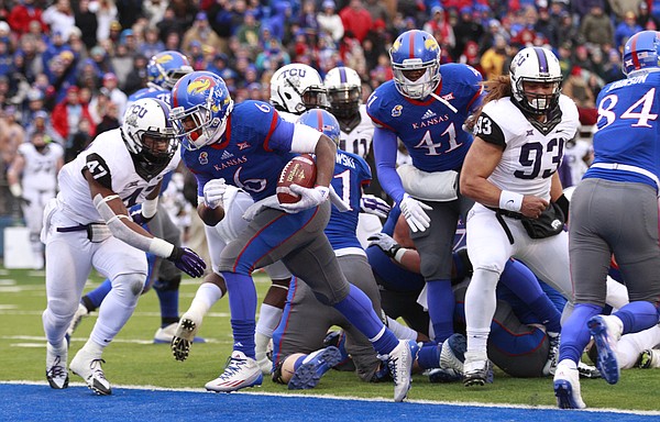 Kansas running back Corey Avery runs in the Jayhawks first touchdown against TCU during the first quarter on Saturday, Nov. 15, 2014 at Memorial Stadium.