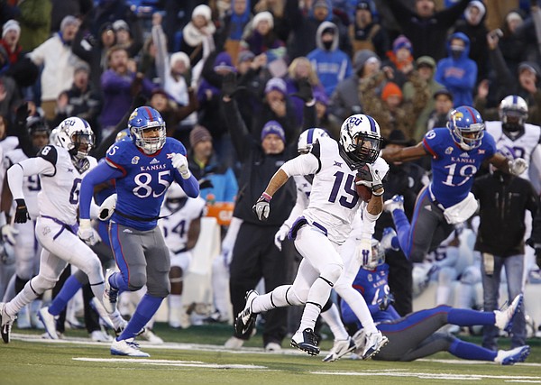 TCU return man Cameron Echols-Luper runs back a punt for a touchdown and the lead as he is tailed by Kansas special teams player Trent Smiley during the third quarter on Saturday, Nov. 15, 2014 at Memorial Stadium.