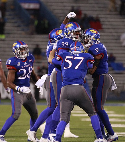 Kansas defensive lineman Tedarian Johnson is surrounded by teammates after recovering a fumble by TCU during the fourth quarter on Saturday, Nov. 15, 2014 at Memorial Stadium.