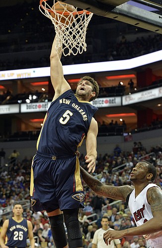 New Orleans Pelicans' Jeff Withey (5) dunks over the defense of Miami Heat's Shawn Jones during the fourth quarter of an NBA basketball preseason game in Louisville, Ky., Saturday, Oct. 4, 2014. New Orleans defeated Miami 98-86. (AP Photo/Timothy D. Easley)
