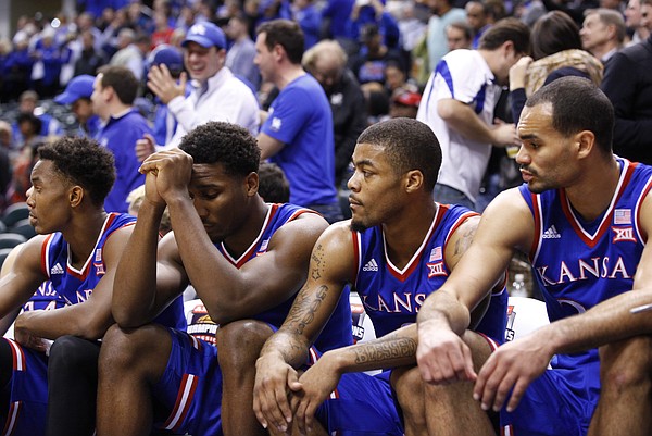 Kansas players Devonte Graham, left, Wayne Selden, Frank Mason and Perry Ellis watch during the final seconds of the Jayhawks' 72-40 loss to Kentucky during the Champions Classic on Tuesday, Nov. 18, 2014 at Bankers Life Fieldhouse in Indianapolis.