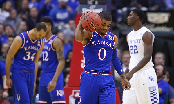 Kansas guard Frank Mason III (0) give the ball a hard bounce in frustration after a string of Jayhawk fouls during the first half of the Champions Classic on Tuesday, Nov. 18, 2014 at Bankers Life Fieldhouse in Indianapolis.