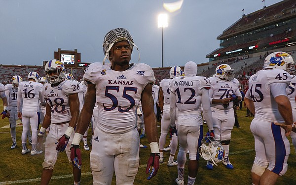 Kansas linebacker Michael Reynolds looks in the direction of the scoreboard while he and his teammates gather to leave the field following the Jayhawks' 44-7 loss to the Sooners on Saturday, Nov. 22, 2014 at Memorial Stadium in Norman, Oklahoma.