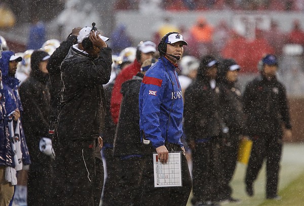 Rain pours down on interim head coach Clint Bowen as he watches an extra point by Oklahoma go through the uprights during the third quarter on Saturday, Nov. 22, 2014 at Memorial Stadium in Norman, Oklahoma.