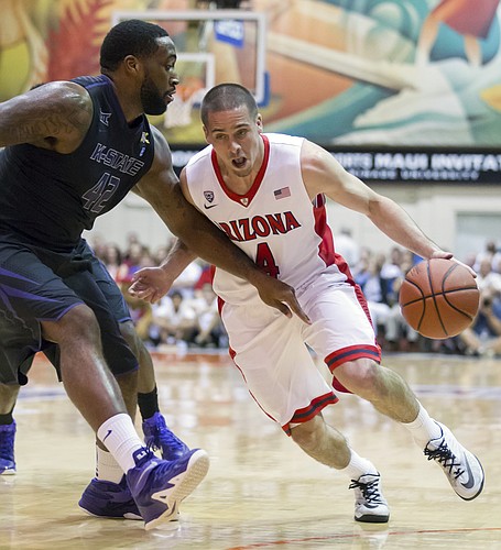 Arizona guard T.J. McConnell (4) attempts to drive past Kansas State forward Thomas Gipson (42) in the first half of an NCAA college basketball game at the Maui Invitational on Tuesday, Nov. 25, 2014, in Lahaina, Hawaii. (AP Photo/Eugene Tanner)