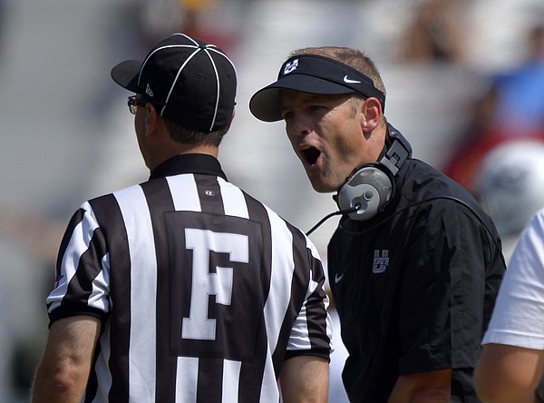 Utah State head coach Matt Wells, right, yells at a referee during the first half of an NCAA college football game against Southern California, Saturday, Sept. 21, 2013, in Los Angeles. (AP Photo/Mark J. Terrill)

