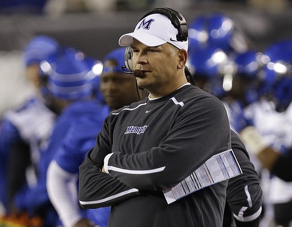  In this Oct. 4, 2014, file photo, Memphis coach Justin Fuente watches from the sideline in the first half of an NCAA college football game against Cincinnati in Cincinnati. Fuente said he saw plenty of potential in Memphis when he was hired to take over the program in December 2011. Now, his faith is being rewarded as Memphis could clinch at least a share of the American Athletic Conference title with a victory Saturday against Connecticut. (AP Photo/Al Behrman, File)
