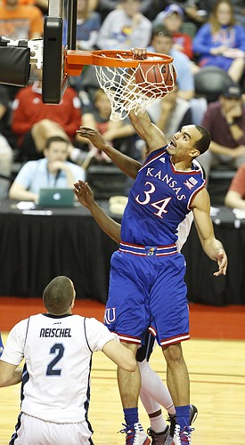 Kansas forward Perry Ellis (34) delivers a put-back dunk over Rhode Island forward Jarelle Reischel (2) during the first half on Thursday, Nov. 27, 2014 at the HP Field House in Kissimmee, Florida.