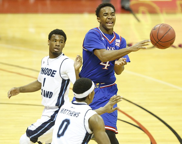Kansas guard Devonte Graham (4) tosses a pass as he is defended by Rhode Island guard E.C. Matthews (0) and guard Jarvis Garrett (1) during the second half on Thursday, Nov. 27, 2014 at the HP Field House in Kissimmee, Florida.