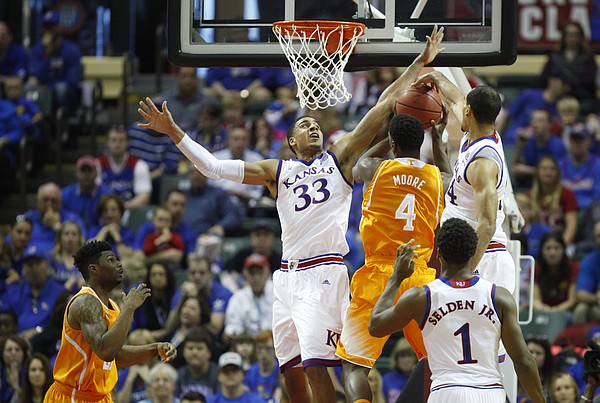 Kansas forward Landen Lucas (33) and forward Perry Ellis look to smother a shot from Tennessee forward Armani Moore (4) during the first half on Friday, Nov. 28, 2014 at the HP Field House in Kissimmee, Florida.