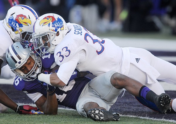 Kansas Cassius Sendish (33) tackles Wildcat receiver Tyler Locket shy of the goal line in the first-half of the Jayhawks game against the Kansas State Wildcats Saturday in Manhattan. 