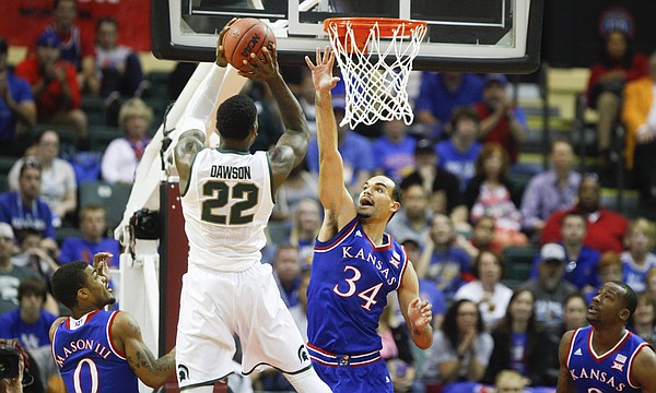 Kansas forward Perry Ellis (34) defends against a shot from Michigan State guard/forward Branden Dawson (22) during the first half on Sunday, Nov. 30, 2014 at the HP Field House in Kissimmee, Florida. Also pictured are KU guard Frank Mason, left, and forward Cliff Alexander.