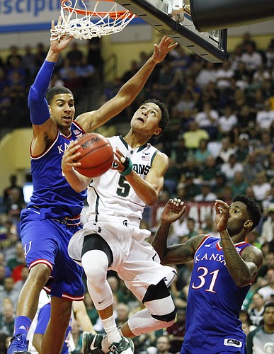 Kansas forward Landen Lucas, left, and forward Jamari Traylor (31) defend against a drive by Michigan State guard Bryn Forbes (5) during the second half on Sunday, Nov. 30, 2014 at the HP Field House in Kissimmee, Florida.