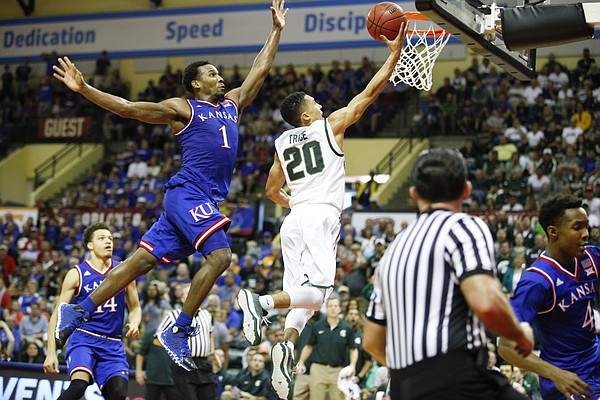 Kansas guard Wayne Selden Jr. (1) gets airborne before pinning a layup by Michigan State guard Travis Trice (20) against the backboard for a block during the second half on Sunday, Nov. 30, 2014 at the HP Field House in Kissimmee, Florida.
