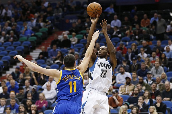 Minnesota Timberwolves forward Andrew Wiggins (22) takes a shot against Golden State Warriors guard Klay Thompson (11) during the first half of an NBA basketball game Monday, Dec, 8, 2014, in Minneapolis. (AP Photo/Stacy Bengs)
