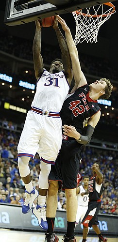 Kansas forward Jamari Traylor (31) gets inside for a bucket and a foul from Utah forward Jakob Poeltl (42) during the second half on Saturday, Dec. 13, 2014 at Sprint Center