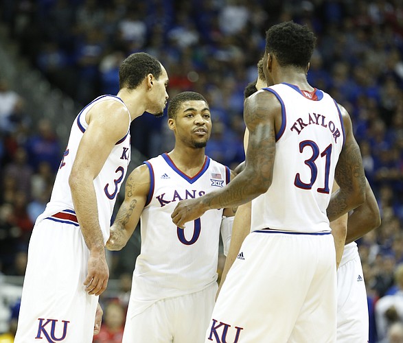 Kansas guard Frank Mason III (0) huddles the Jayhawks before free throw attempts by Brannen Greene with seconds to play during the second half on Saturday, Dec. 13, 2014 at Sprint Center