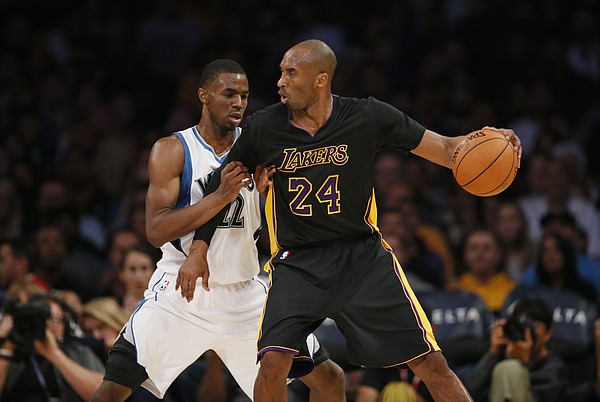 Minnesota Timberwolves' Andrew Wiggins defends against Los Angeles Lakers' Kobe Bryant during the first half of an NBA basketball game Friday, Nov. 28, 2014, in Los Angeles