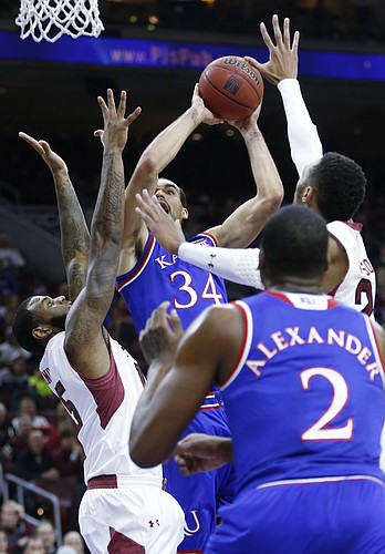 Kansas forward Perry Ellis (34) tries to power his way to the goal past Temple defenders against the Owls Monday at the Wells Fargo Center in Philadelphia, PA.