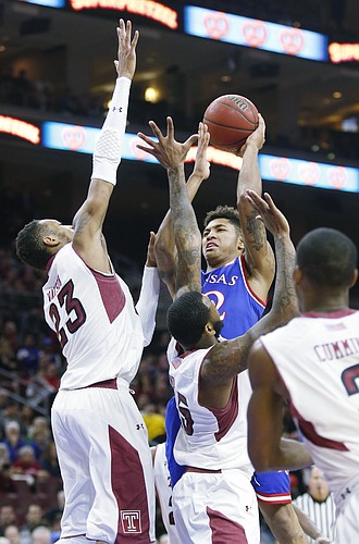Kansas guard Kelly Oubre, Jr. is surrounded by Temple defenders during the Jayhawk's game against the Owls Monday at the Wells Fargo Center in Philadelphia, PA.