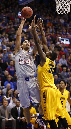 Kansas forward Perry Ellis (34) turns for a shot over Kent State forward Jimmy Hall (35) during the first half on Tuesday, Dec. 30, 2014 at Allen Fieldhouse.