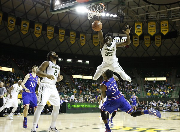 Baylor forward Johnathan Motley (35) bowls over Kansas forward Jamari Traylor (31) on a dunk during the first half on Wednesday, Jan. 7, 2014 at Ferrell Center in Waco, Texas. The dunk was called back and Motley was whistled for an offensive foul on the play.
