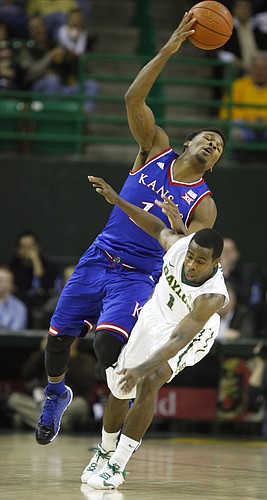 Kansas guard Wayne Selden Jr. (1) and Baylor guard Kenny Chery (1) collide at mid court while competing for a ball during the first half on Wednesday, Jan. 7, 2014 at Ferrell Center in Waco, Texas.