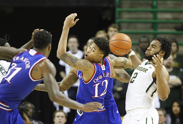 Kansas guard Kelly Oubre Jr. (12) tangles for a loose ball with Baylor forward Rico Gathers (2) during the second half on Wednesday, Jan. 7, 2014 at Ferrell Center in Waco, Texas.