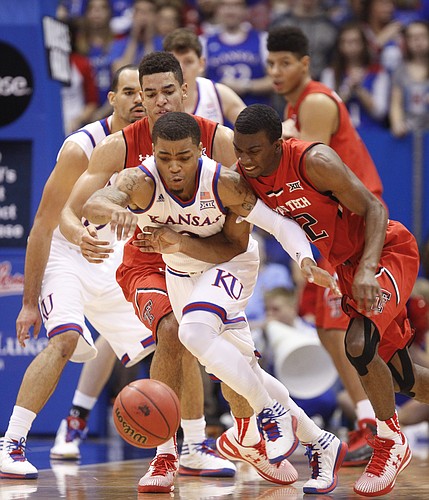 Kansas guard Frank Mason III (0) hustles for a loose ball after knocking it away from Texas Tech guard Keenan Evans (12) during the first half on Saturday, Jan.10, 2015 at Allen Fieldhouse.