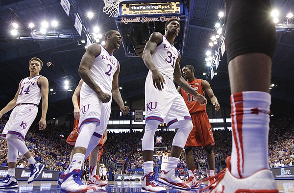 Kansas forward Cliff Alexander (2) celebrates a dunk by Kansas forward Jamari Traylor (31) as he casts a glare at at Texas Tech player during the first half on Saturday, Jan.10, 2015 at Allen Fieldhouse. At left is KU guard Brannen Greene.