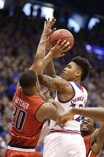 Kansas guard Kelly Oubre Jr. (12) turns for a shot against Texas Tech guard Toddrick Gotcher (20) during the first half on Saturday, Jan.10, 2015 at Allen Fieldhouse.