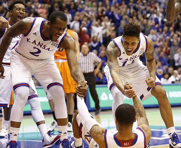 Teammates Kansas forward Cliff Alexander (2) and guard Kelly Oubre Jr. (12) come in to celebrate with Frank Mason III after Mason drew a foul on a bucket during the first half, Tuesday, Jan. 13, 2015 at Allen Fieldhouse.