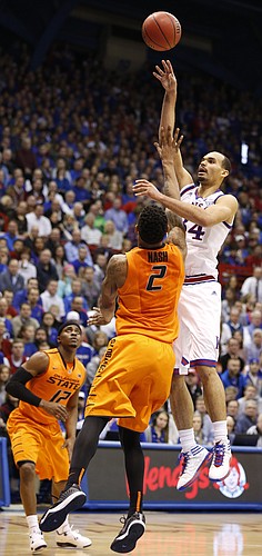 Kansas forward Perry Ellis (34) turns for a shot over Oklahoma State forward Le'Bryan Nash (2) during the first half, Tuesday, Jan. 13, 2015 at Allen Fieldhouse.