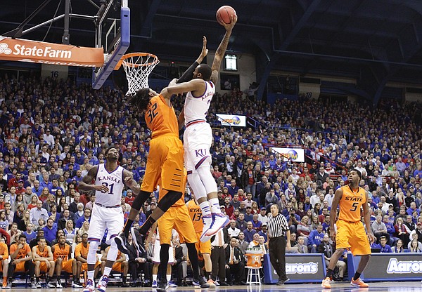 Kansas forward Cliff Alexander (2) takes some contact from Oklahoma State forward/center Anthony Allen Jr. (32) as he elevates for a dunk during the first half, Tuesday, Jan. 13, 2015 at Allen Fieldhouse.