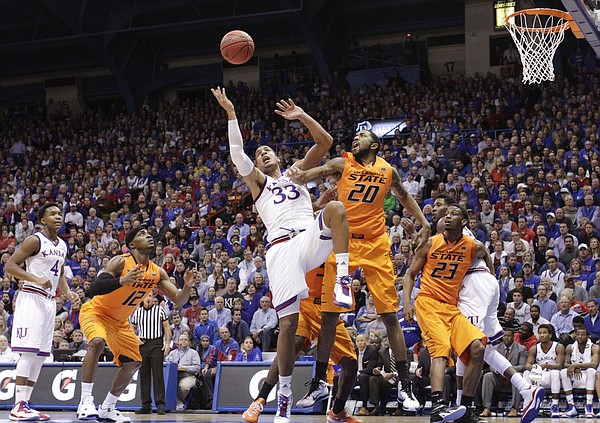 Kansas forward Landen Lucas (33) fights for a rebound with Oklahoma State forward Michael Cobbins (20) during the second half, Tuesday, Jan. 13, 2015 at Allen Fieldhouse.