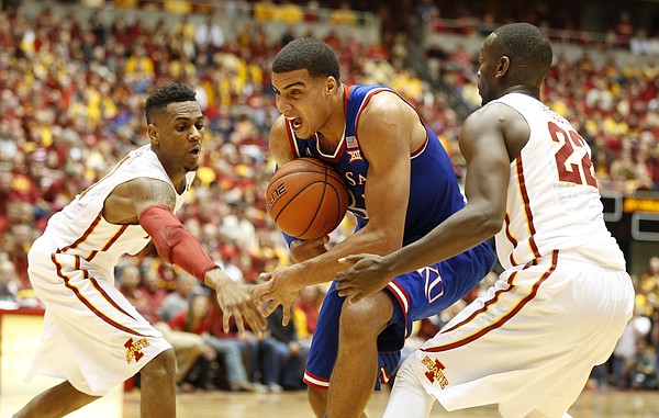 Kansas forward Landen Lucas (33) loses the ball as it is stripped by Iowa State forward Dustin Hogue (22) and guard Monte Morris (11) during the first half on Saturday, Jan. 17, 2015 at Hilton Coliseum.