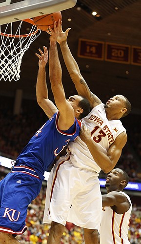 Kansas forward Perry Ellis (34) has his shot blocked by Iowa State guard Bryce Dejean-Jones (13) during the second half on Saturday, Jan. 17, 2015 at Hilton Coliseum. At right is ISU guard Dustin Hogue.