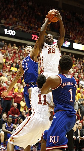 Iowa State forward Dustin Hogue (22) pulls away a rebound from Kansas guard Kelly Oubre Jr. (12) with a minute remaining in regulation on Saturday, Jan. 17, 2015 at Hilton Coliseum.