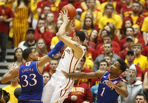 Iowa State forward Abdel Nader (2) is defended by Kansas forward Landen Lucas (33) and guard Wayne Selden Jr. during the second half on Saturday, Jan. 17, 2015 at Hilton Coliseum.