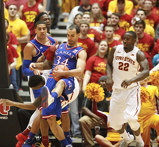Kansas forward Perry Ellis (34) pulls a rebound away from Iowa State guard Monte Morris during the second half on Saturday, Jan. 17, 2015 at Hilton Coliseum. Also pictured are Kansas forward Landen Lucas and Iowa State forward Dustin Hogue.