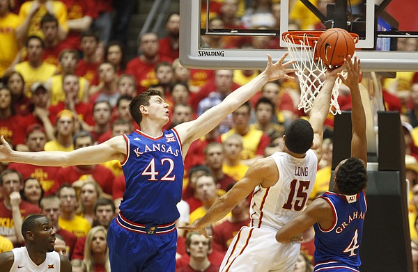 Iowa State guard Naz Long (15) squeezes in for a bucket between Kansas forward Hunter Mickelson (42) and  guard Devonte Graham during the second half on Saturday, Jan. 17, 2015 at Hilton Coliseum.