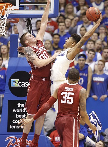 Kansas guard Kelly Oubre Jr. (12) pulls back for an attempted dunk against Oklahoma forward Ryan Spangler (00) during the second half on Monday, Jan. 19, 2015 at Allen Fieldhouse.
