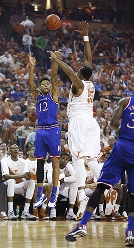 Kansas guard Kelly Oubre Jr. (12) puts up a three over Texas center Cameron Ridley (55) during the first half, Saturday, Jan. 24, 2015 at Frank Erwin Center in Austin, Texas.