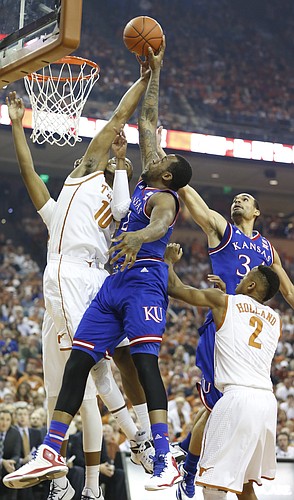 Kansas forward Cliff Alexander (2) fights for a rebound with Texas forward Jonathan Holmes (10) during the first half, Saturday, Jan. 24, 2015 at Frank Erwin Center in Austin, Texas.