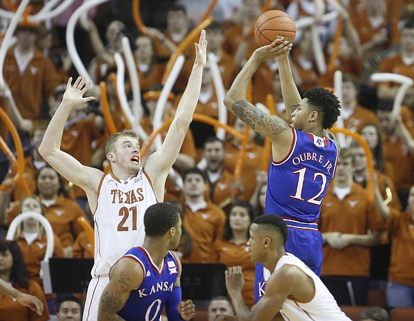 Kansas guard Kelly Oubre Jr. (12) puts up a shot over Texas forward Connor Lammert (21) during the second half, Saturday, Jan. 24, 2015 at Frank Erwin Center in Austin, Texas.