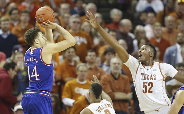 Kansas guard Brannen Greene (14) pulls up for a three as he is defended by Texas forward Myles Turner (52) during the second half, Saturday, Jan. 24, 2015 at Frank Erwin Center in Austin, Texas.
