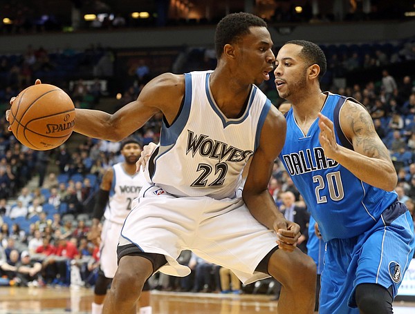 Minnesota Timberwolves’ Andrew Wiggins (22) tries to move around Dallas Mavericks’ Devin Harris (20) in the first quarter of an NBA basketball game, Wednesday, Jan. 21, 2015, in Minneapolis. (AP Photo/Jim Mone)
