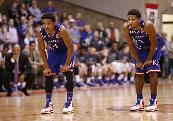 Kansas guards Devonte Graham (4) and Wayne Selden Jr. watch a pair of free throws from teammate Frank Mason with seconds remaining on Wednesday, Jan. 28, 2015 in Fort Worth, Texas.