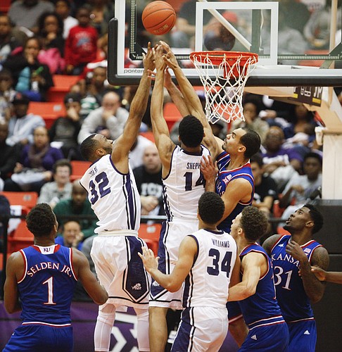 Kansas forward Perry Ellis battles down low for a rebound with TCU Horned Frogs guard Trey Zeigler (32) and center Karviar Shepherd during the second half at Wilkerson-Greines Activity Center on Wednesday, Jan. 28, 2015 in Fort Worth, Texas.