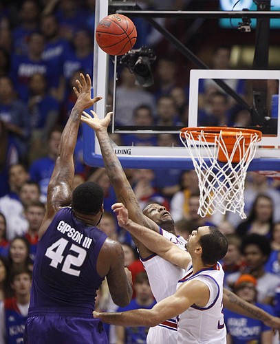 Kansas State forward Thomas Gipson (42) puts up a shot over Kansas forward Perry Ellis, right, and forward Cliff Alexander during the first half on Saturday, Jan. 31, 2015 at Allen Fieldhouse.
